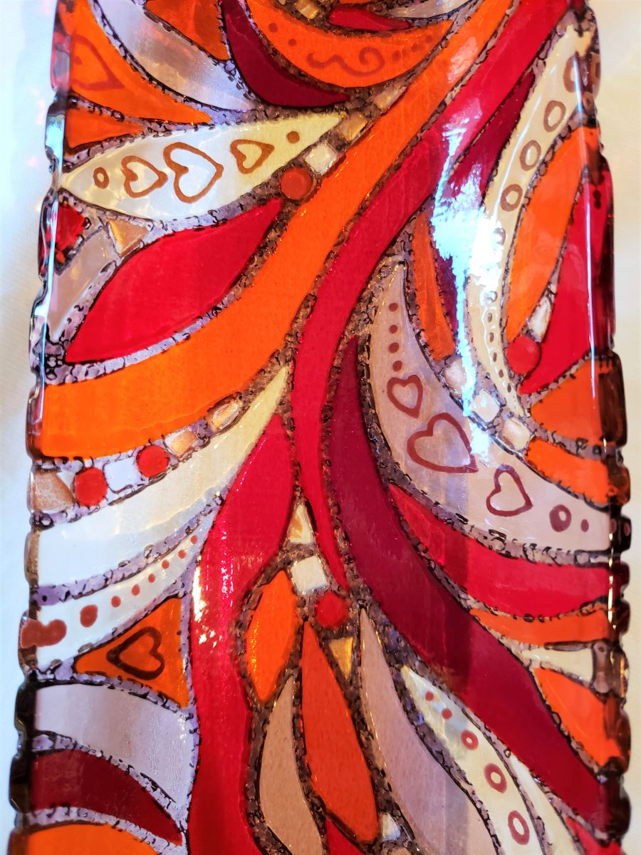 close up of artwork detail on red server dish