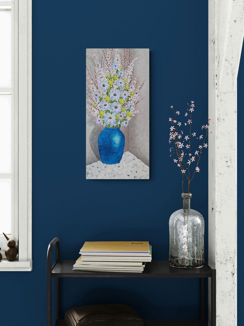 painting of flowers on a blue wall