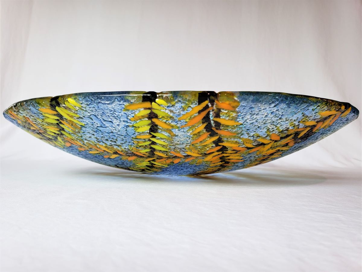 View of the side of blue glass art bowl by jeweliyana