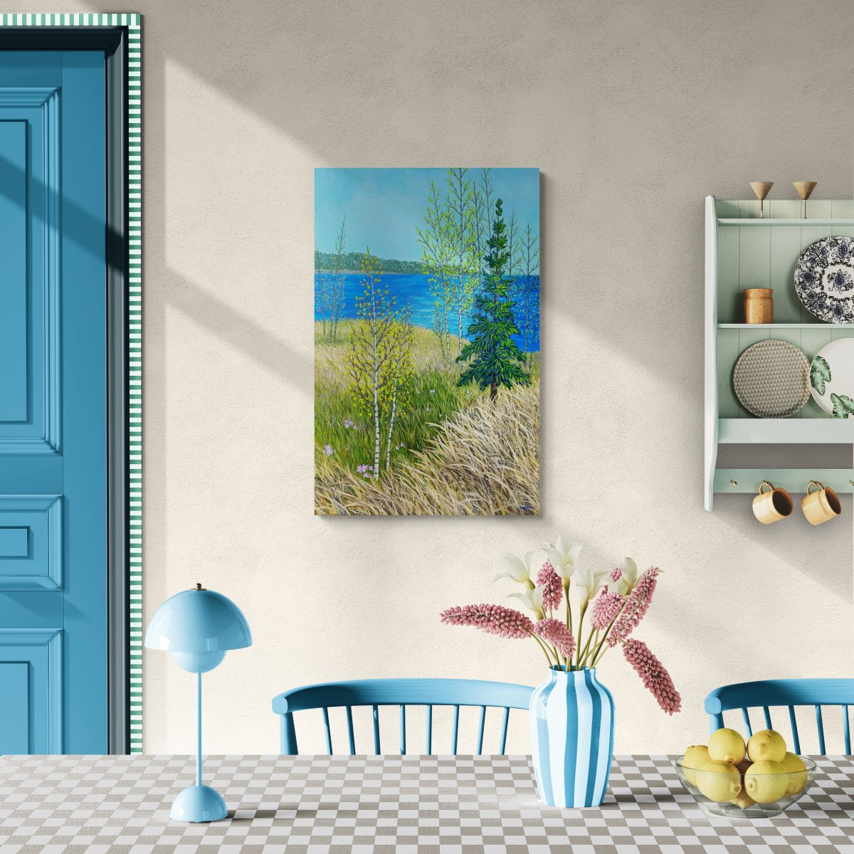 Room interior with a painting of a landscape or water adn trees. Blue door, and decorative items on a shelf.