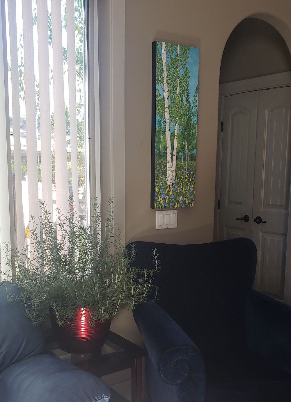 Painting of green birch trees shown in a home decor setting