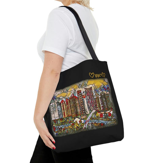 black tote bag with calgary city art on it shown on a woman