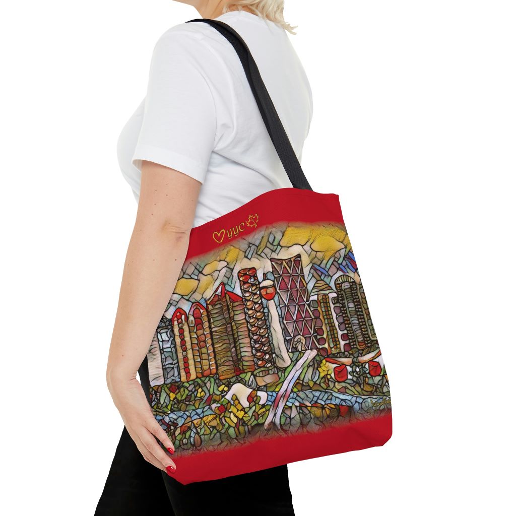 woman with red tote bag that has calgary cityscape artwork on it