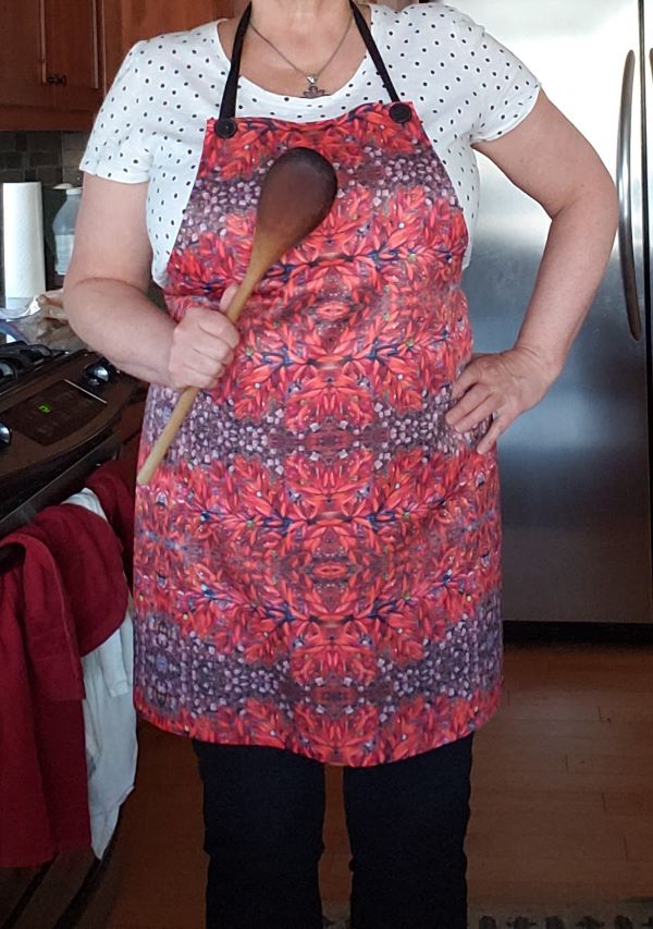 Red patterned apron shown on woman 